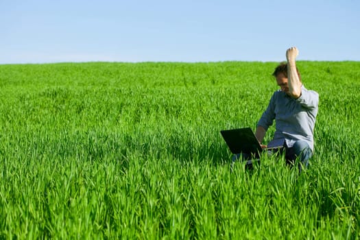 Young man using a laptop outdoors