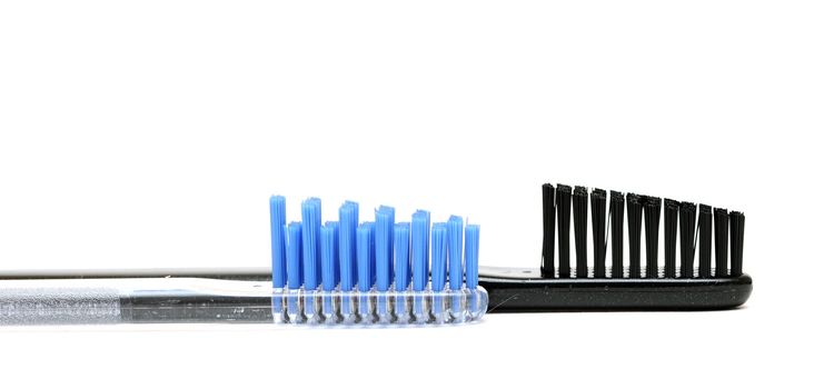 Close up toothbrushes over white background 