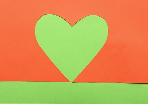close up of paper heart shapes on green background