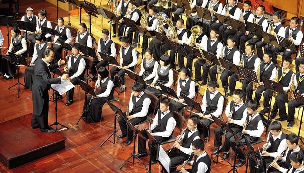 CHENGDU - APR 23: student symphonic band of High School No.7 Chengdu perform on concert on Apr 23,2011 in Chengdu,China.