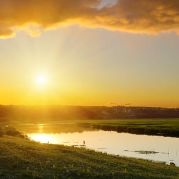 dramatic sunset over river 