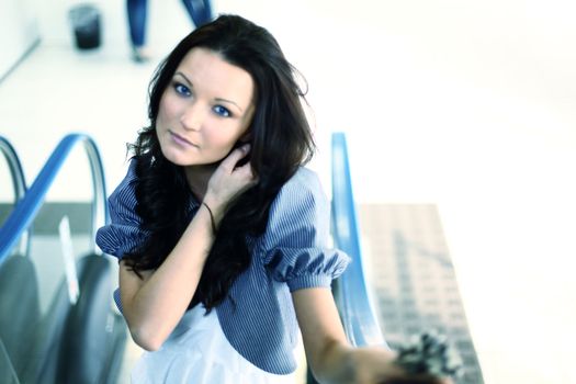 blue eyes women on escalator place close up