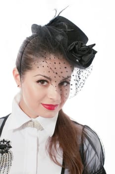 Portrait of young woman wearing the hat with a veil and white blouse with the brooch on her breast