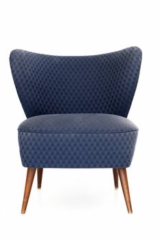 Retro blue upholstered comfy chair with patterned fabric and a curved back isolated on white