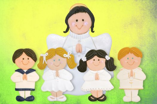 cheerful first communion card, funny kids and angel made of sugar