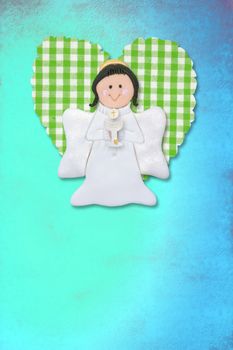 cheerful first communion card, angel and heart on blue background