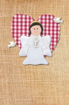 cheerful first communion card, angel in burlap background