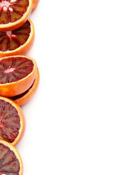 Halves of Perfect Ripe Blood Oranges as Frame closeup on white background