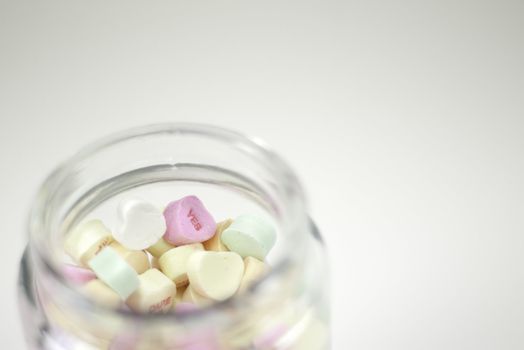 glass jar filled with valentine hearts