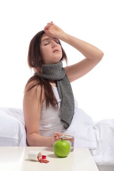 A young woman sitting in bed with a flu. All on white background.