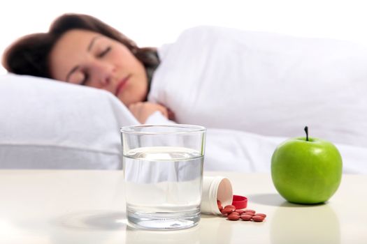 A young woman lying in the bed. All isolated on white background.