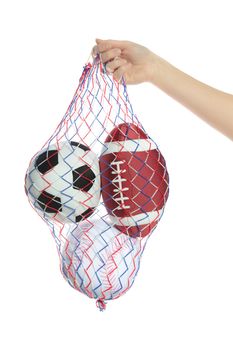 A human hand carrying a bag with several stylized balls in it. All isolated on white background.