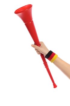 A hand of german supporter holding a vuvuzela, the traditional trumpet of south african supporters.