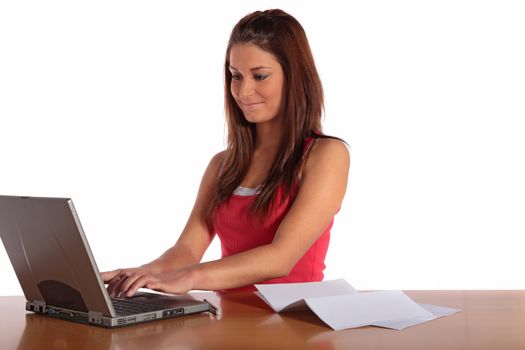 An attractive young woman using a notebook computer. All isolated on white background.