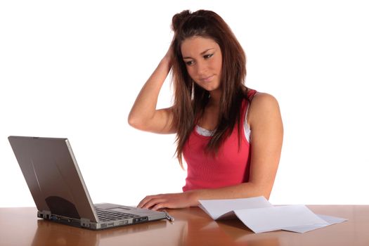 An attractive frustrated student sitting in front of her notebook computer. All isolated on white background.
