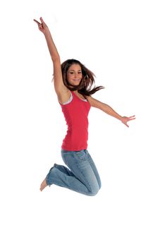 An attractive young woman jumping in front of a plain white background.