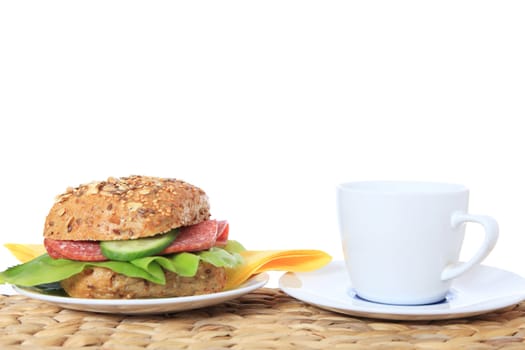 Fine served wheat roll with salami. All on white background.