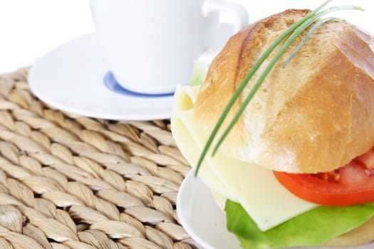 Fine served wheat roll with cheese. All on white background.