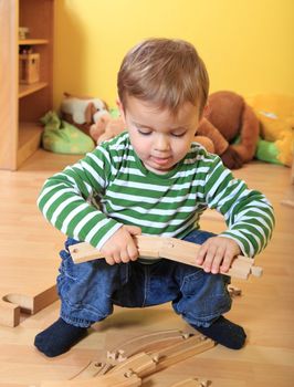 Cute caucasian toddler playing in kindergarten.