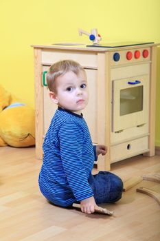 Cute caucasian toddler playing in kindergarten.