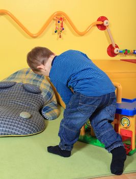 Single kid playing in kindergarten.