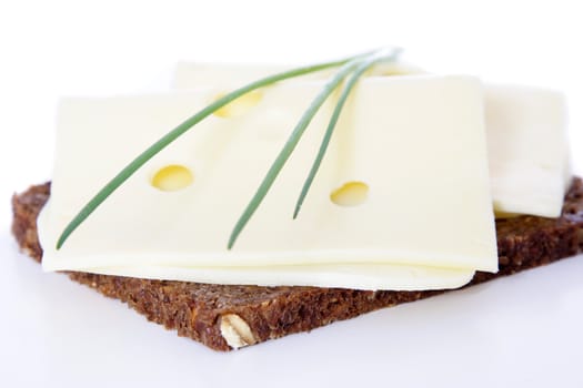 Fine served granary bread with cheese. All on white background.