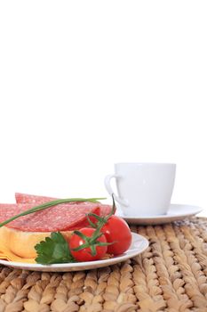 Fine served wheat roll with salami. All on white background.