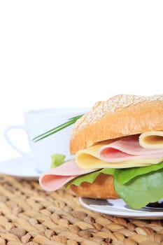 Fine served wheat roll with boiled ham and cheese. All on white background.