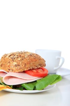 Fine served multi-grain roll with boiled ham. All on white background.