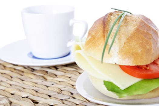 Fine served wheat roll with cheese. All on white background.