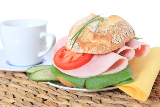 Fine served french roll with boiled ham and cheese. All on white background.