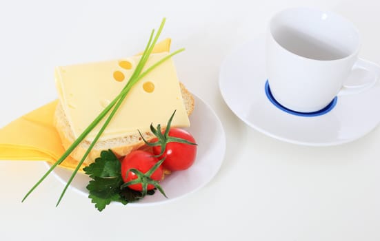 Fine served wheat roll with cheese. All on white background.