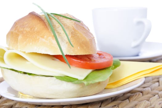 Fine served wheat roll with cheese. All on white background.