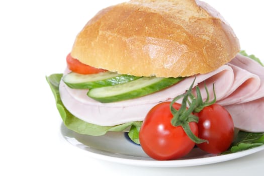 Fine served wheat roll with boiled ham. All on white background.