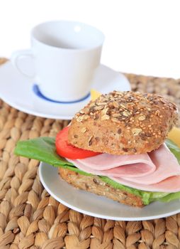 Fine served multi-grain roll with boiled ham. All on white background.