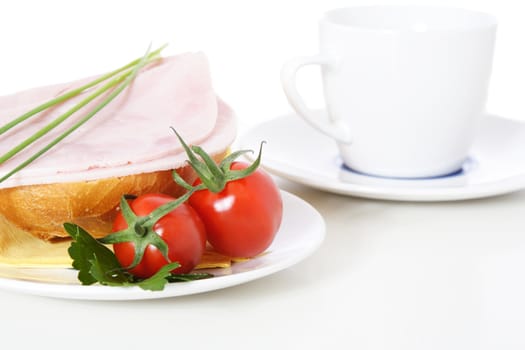 Fine served half wheat roll with boiled ham. All on white background.