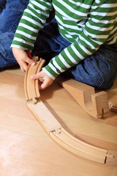 Cute european toddler playing in kindergarten.