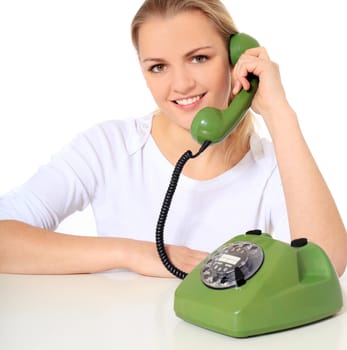 Attractive blond woman making a phone call. All on white background.