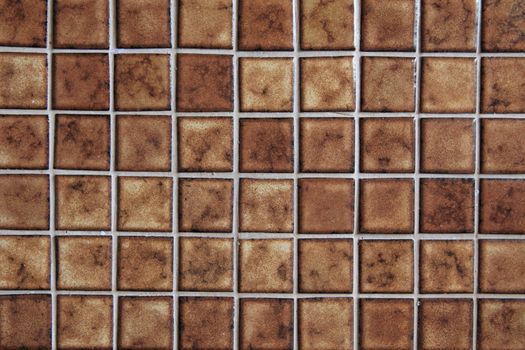 Background of glazed brown tiles.