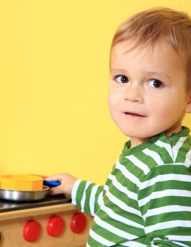 Cute european toddler having fun in kindergarten.