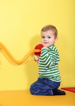 Cute european toddler having fun in kindergarten.