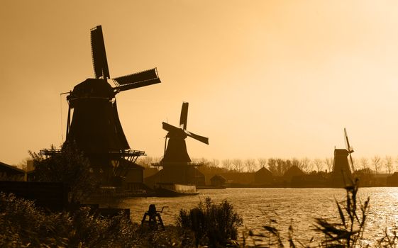 Silhouettes of traditional Dutch windmills in Zaanse Schans.