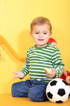 Cute caucasian toddler having fun in kindergarten.