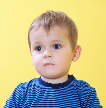 Sad little toddler missing his mum in kindergarten.