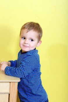 Cute european toddler having fun in kindergarten.