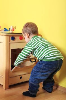 Cute european toddler having fun in kindergarten.