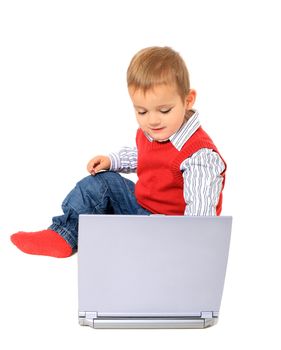 Cute caucasian toddler playing with notebook computer. All isolated on white background.