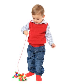 Cute caucasian toddler playing with wooden toy. All isolated on white background.