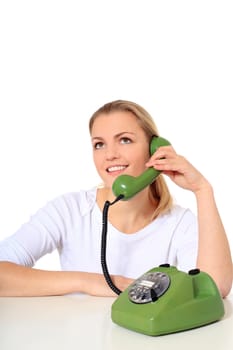 Attractive blond woman making a phone call. All on white background.