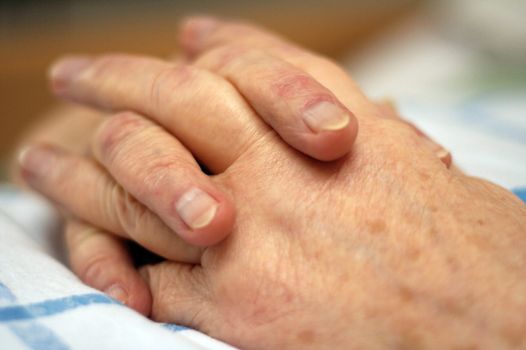 Old wrinkled hands of an elderly person.